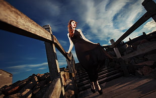Woman wearing black dress in bridge